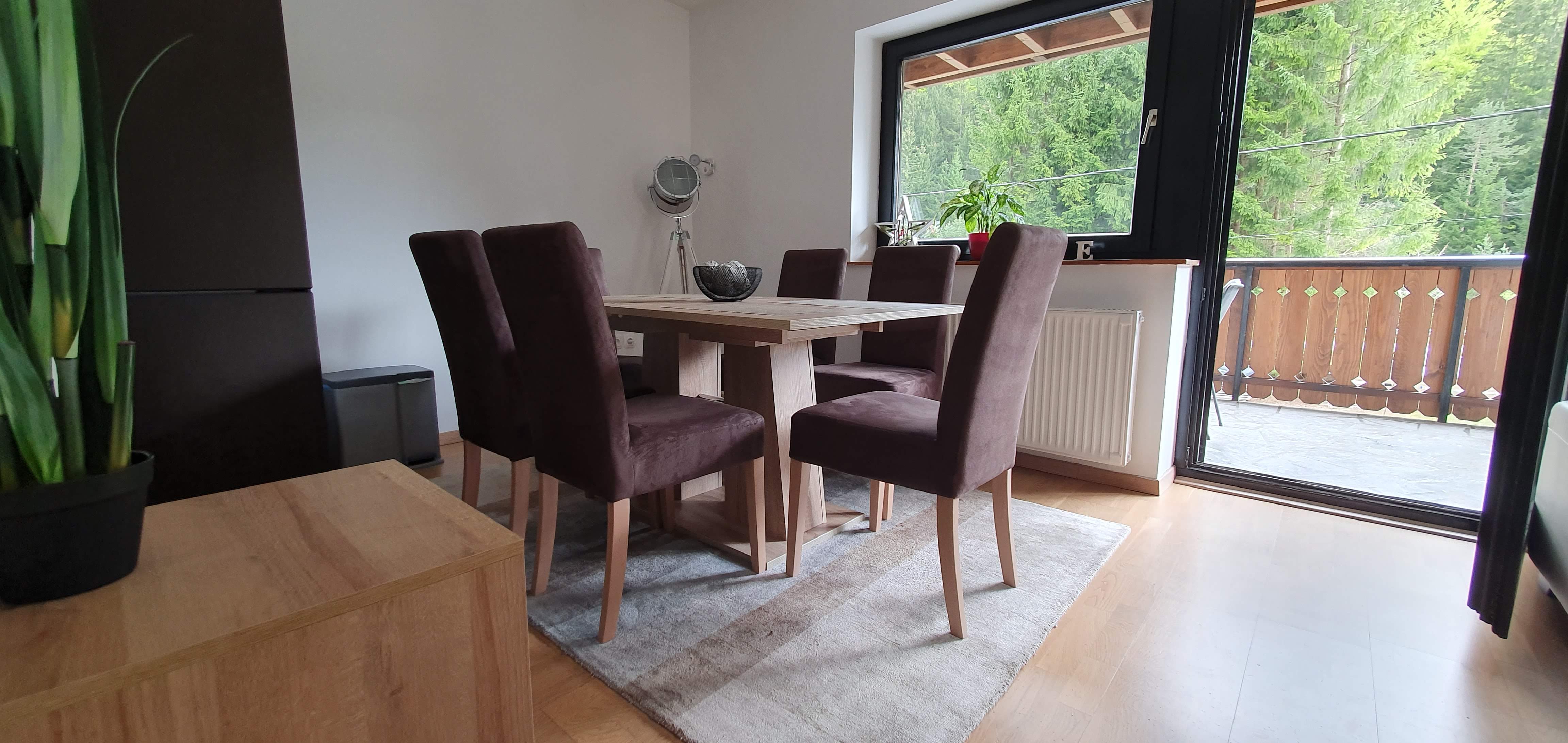 Dining table with view towards the terrace and the forest